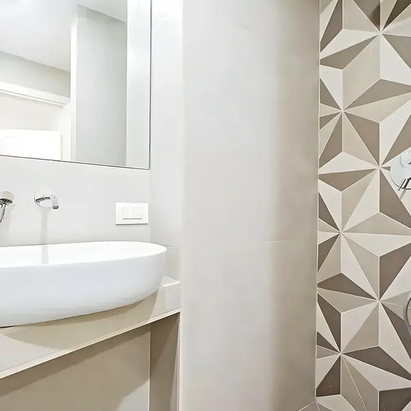 Lavabo sobre encimera continua con la grifería empotrada en el paramento